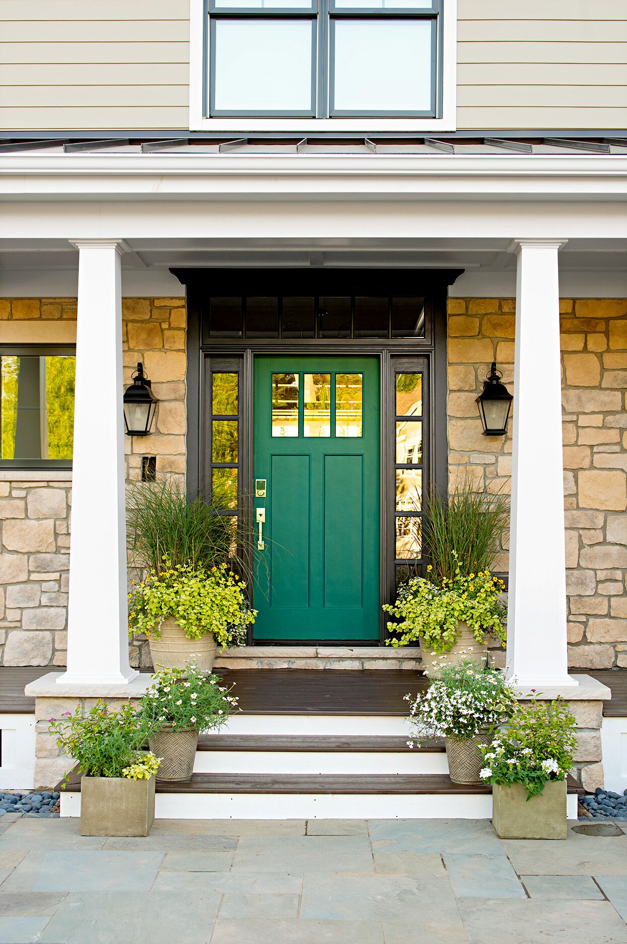 Stone entryway with green door and white pillars